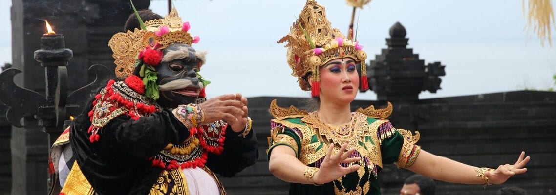 Two people in costumes performing a dance.