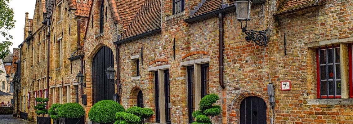 A brick building with trees in the front of it.