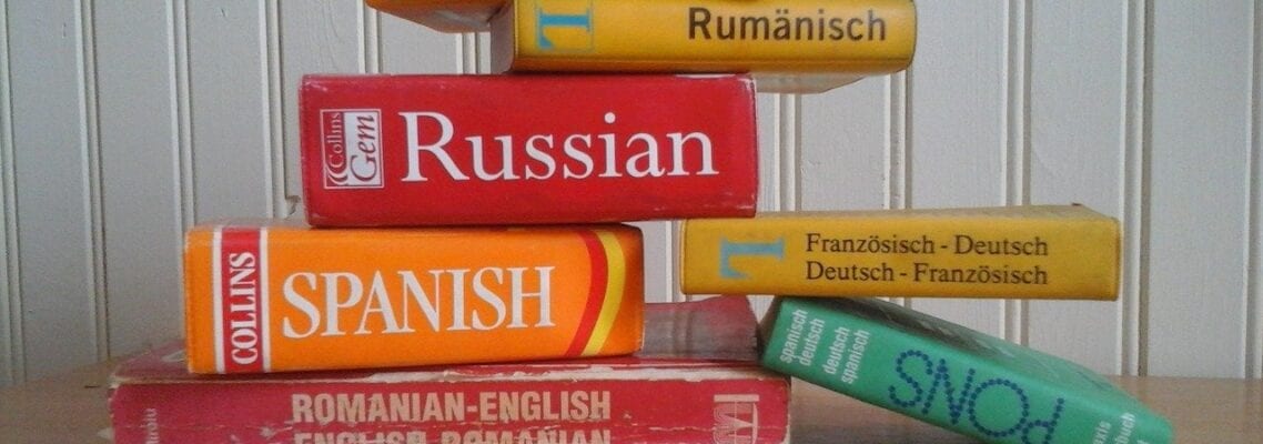 A stack of foreign language books on top of each other.