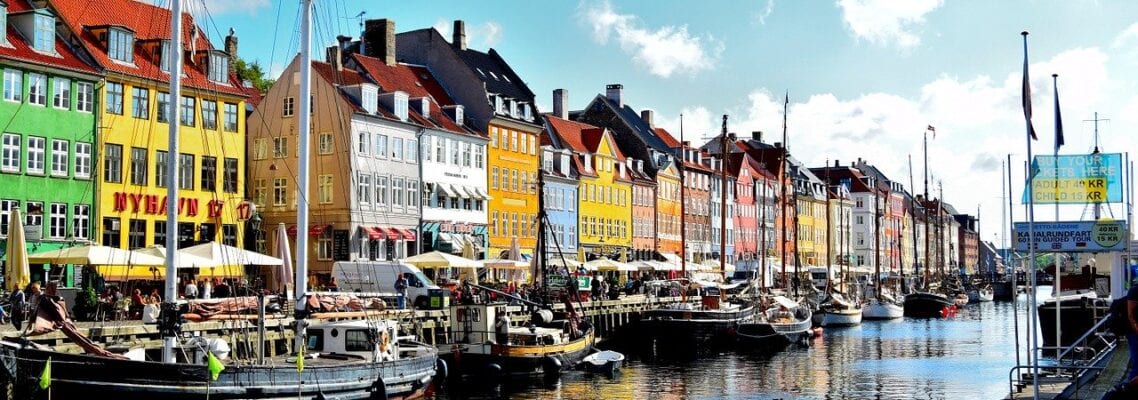 A row of colorful buildings next to the water.