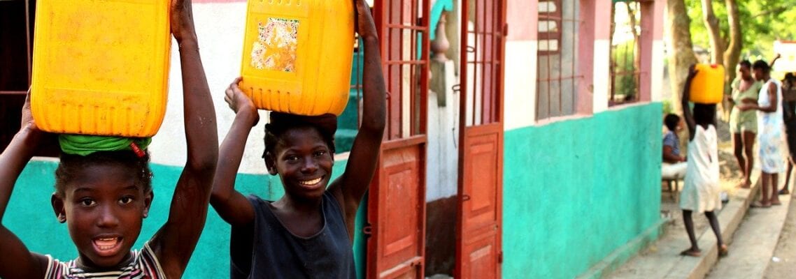 A young boy holding onto a yellow container