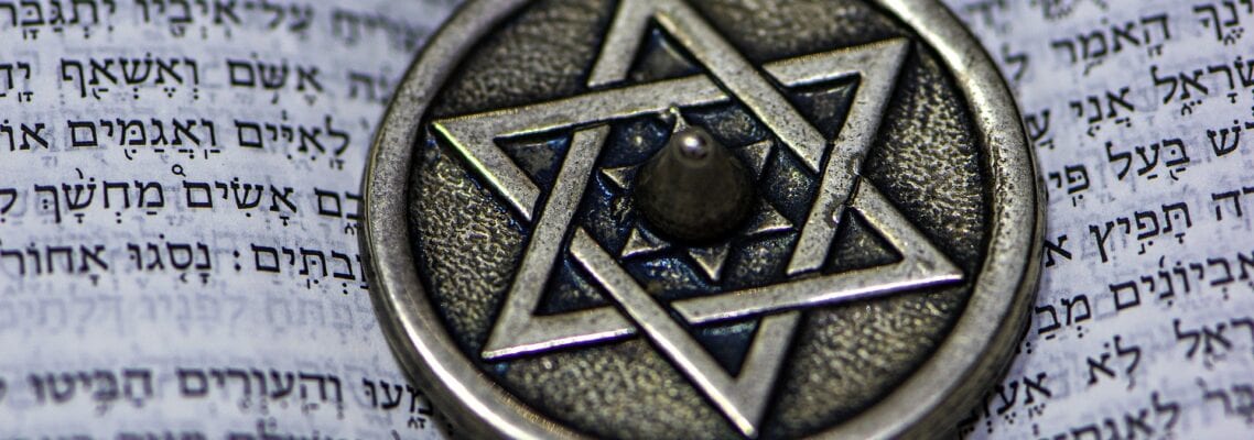 A close up of an old silver star on top of a book.