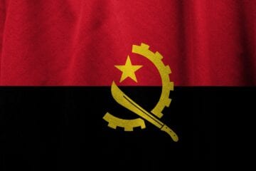 A flag of angola with the symbol for the star and sickle.