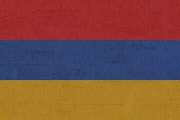 A red, yellow and blue flag with some white on it