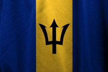 A flag of barbados with the trident symbol on it.