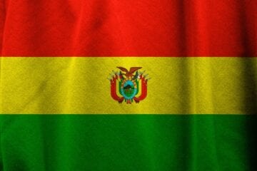 A flag of bolivia with the coat of arms on it.