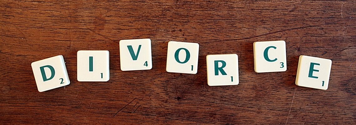 A word written in scrabble tiles on top of a wooden table.