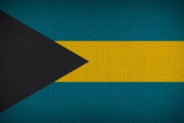 A flag of the bahamas with a black stripe across it.