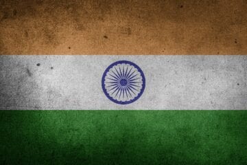 A flag of india with the indian national emblem on it.