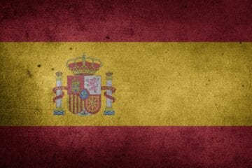 A flag of spain painted on a wall.