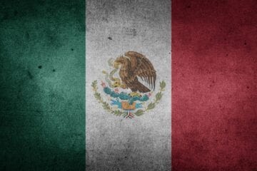 A flag of mexico with the mexican eagle on it.