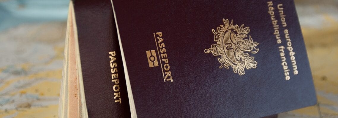 Two passports sitting on top of a table.