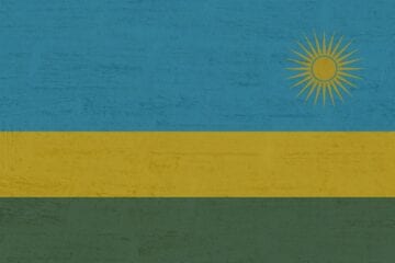 A flag of rwanda with the sun in the background.