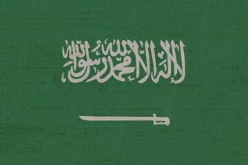 A green background with the flag of saudi arabia.