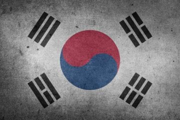 A flag of south korea with the korean symbol on it.