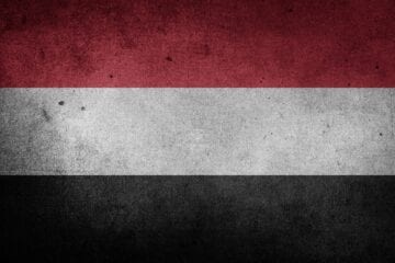 A flag of yemen with a black, white and red background.