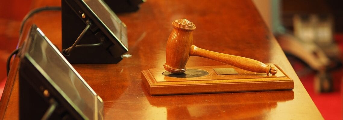 A wooden gavel on top of a table.