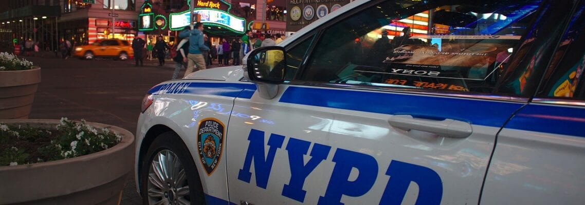 A police car parked on the side of a street.