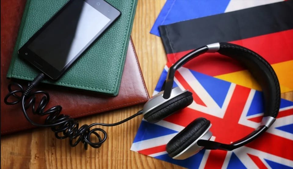 A table with some books and headphones on it