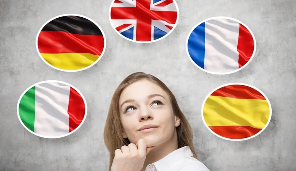 A woman is looking up at the flags of different countries.