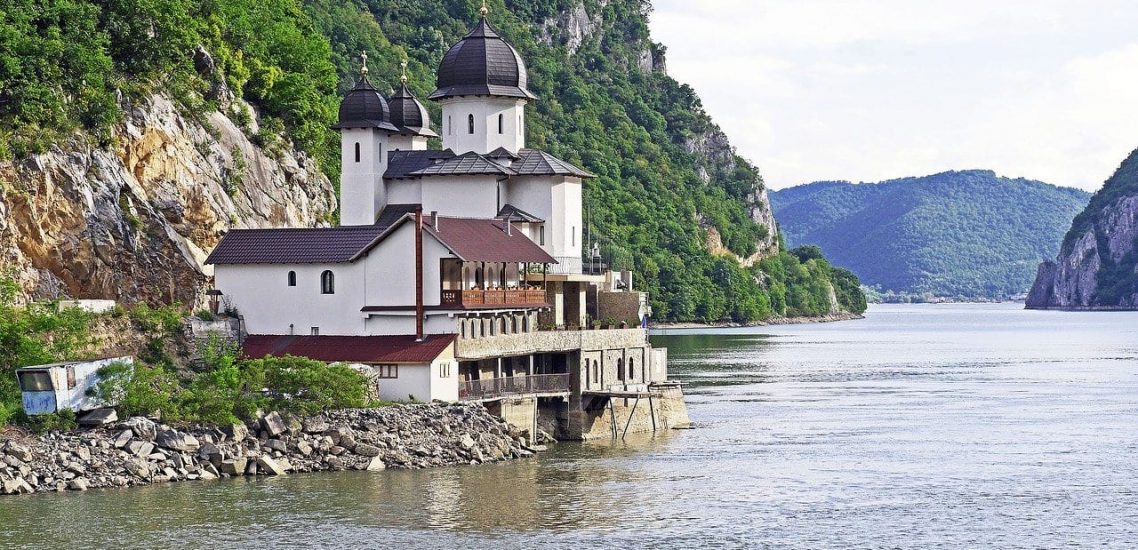 A church on the shore of a lake.